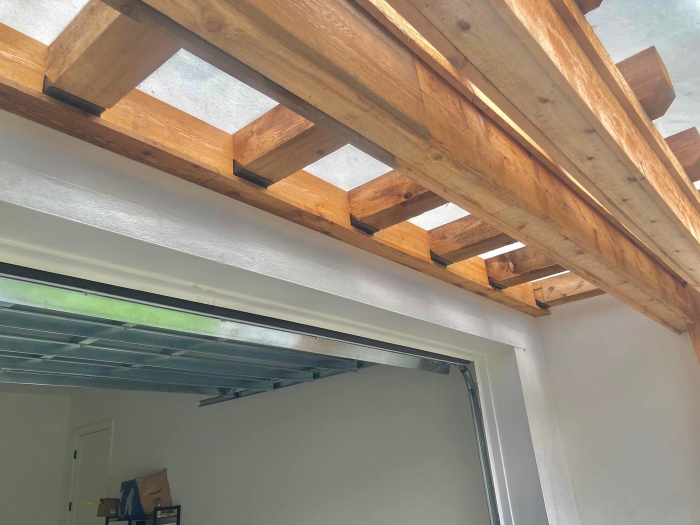 Exposed wood beam ceiling over a garage opening