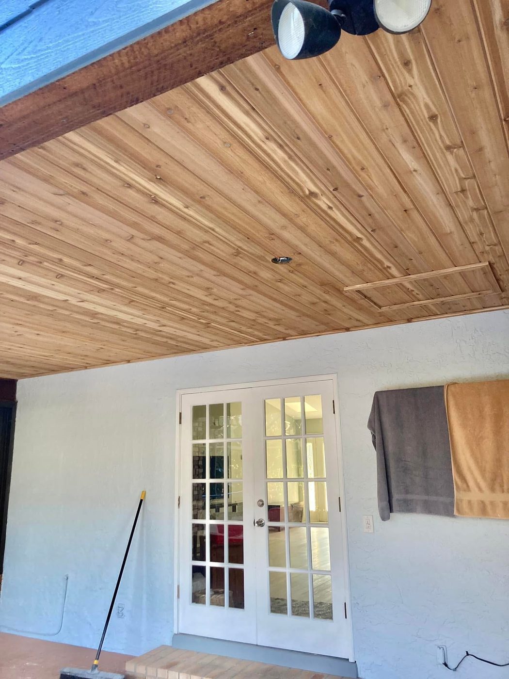 Wood-plank ceiling with French doors
